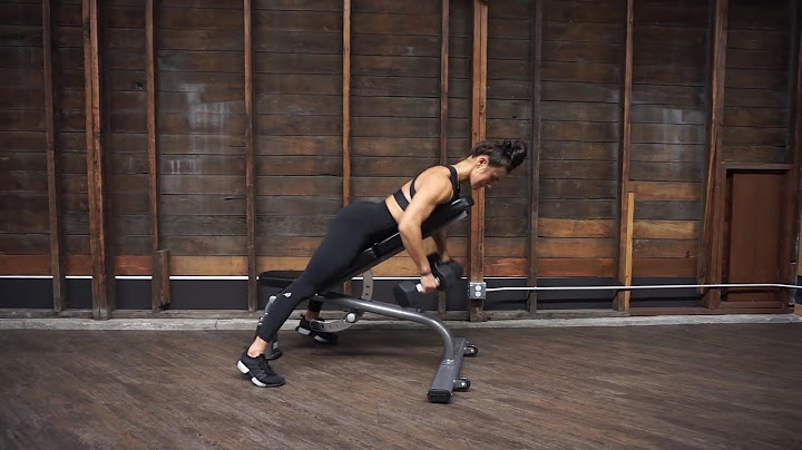 Woman performing a chest supported dumbbell row